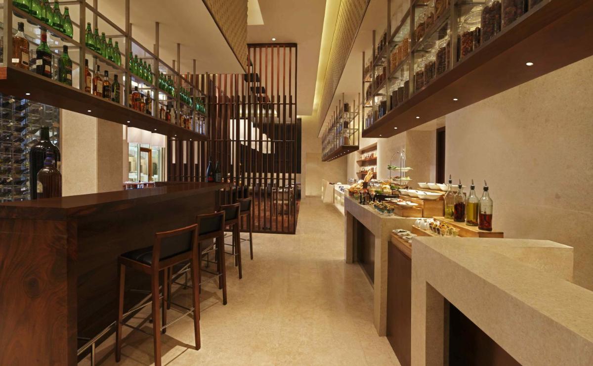 a bar with a bunch of bottles of wine at DoubleTree by Hilton-Pune Chinchwad in Pune