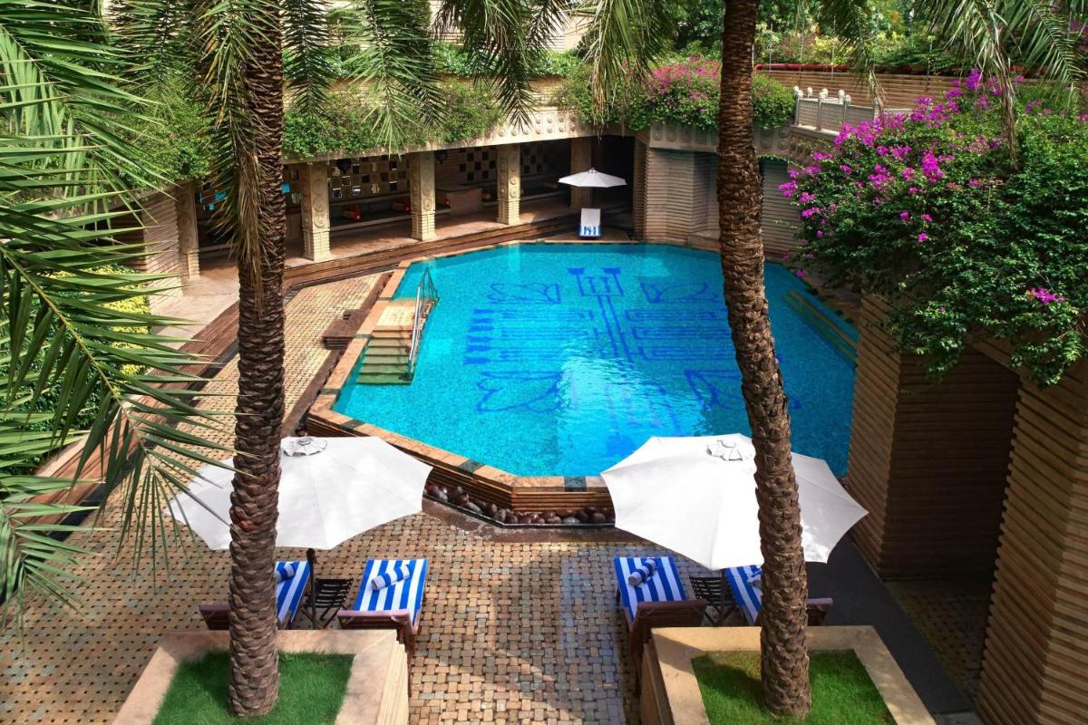 an overhead view of a swimming pool with palm trees at Hyderabad Marriott Hotel & Convention Centre in Hyderabad an overhead view of a swimming pool with palm trees at Hyderabad Marriott Hotel & Convention Centre in Hyderabad