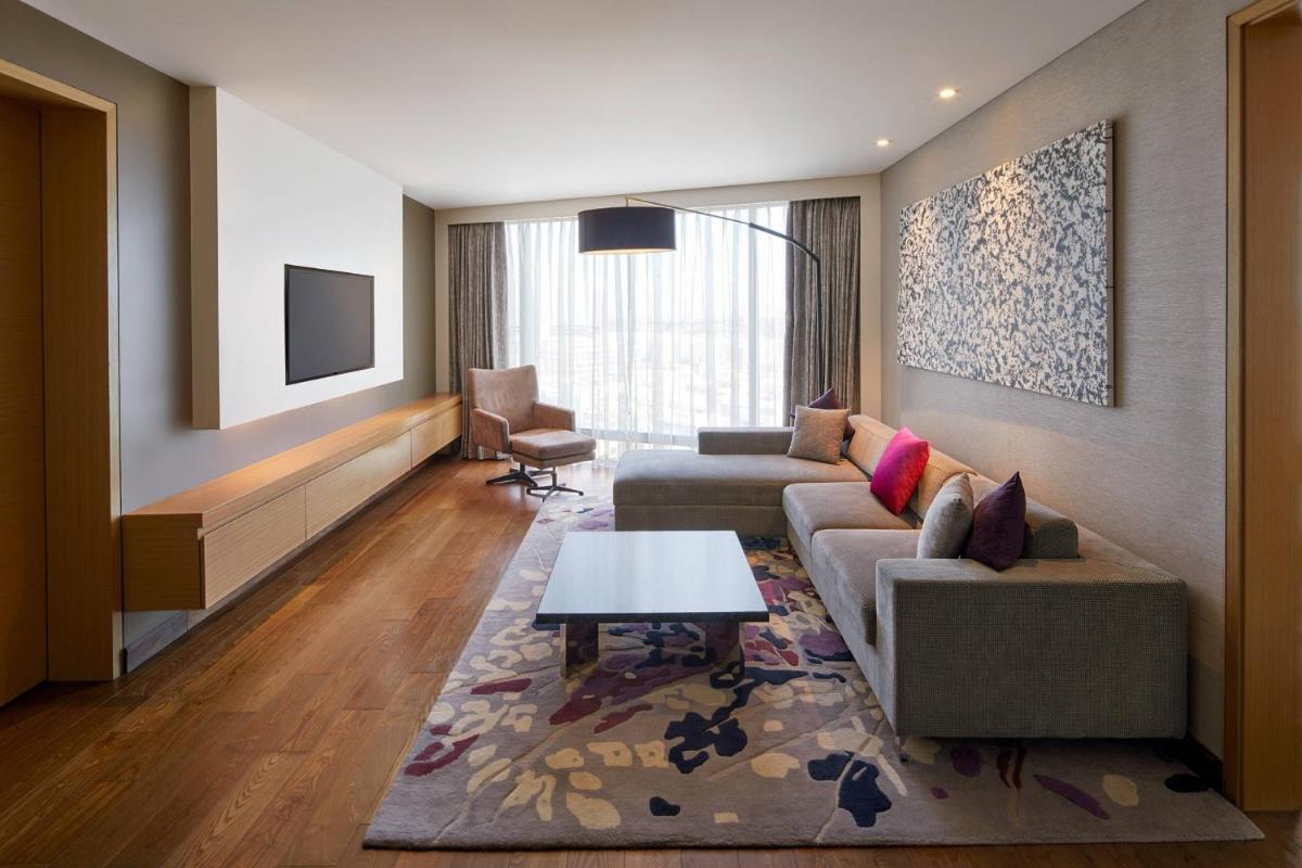 a living room with a couch and a table at Marriott Executive Apartments Hyderabad in Hyderabad