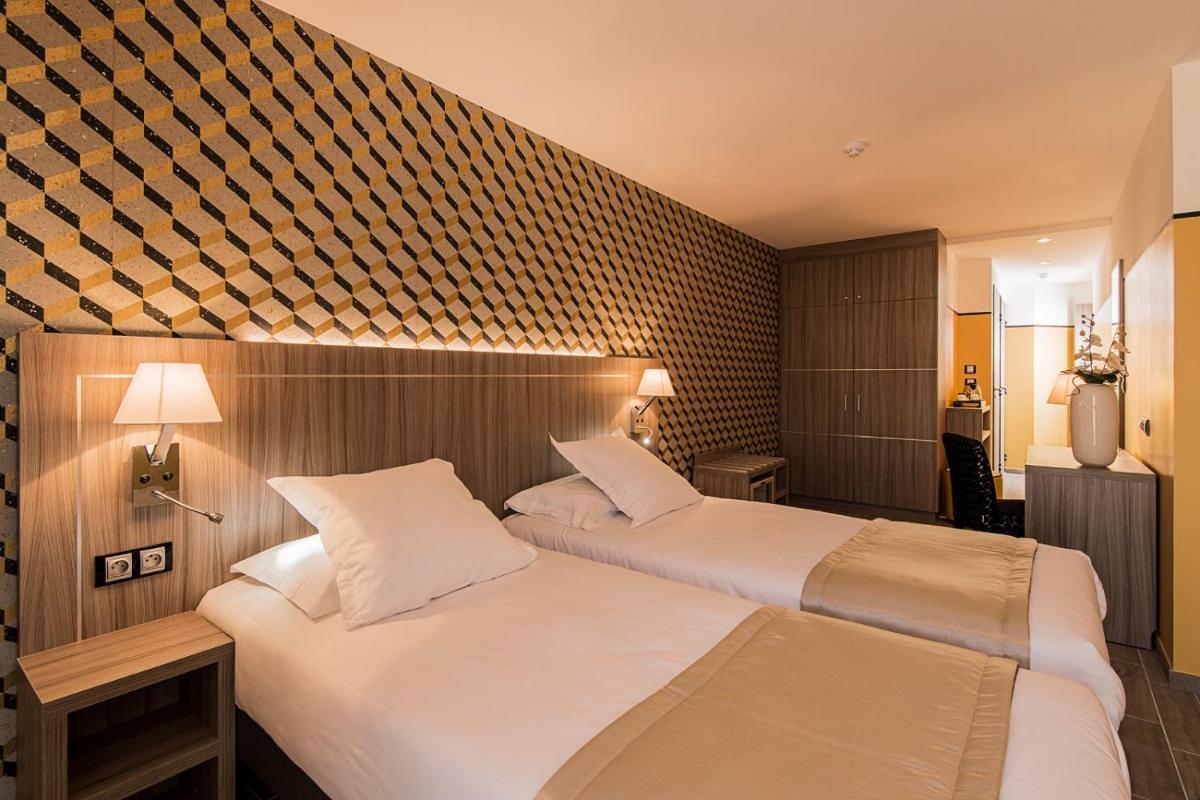 Un ou plusieurs lits dans un hébergement de l'établissement Unique Hôtel Résidence & Spa