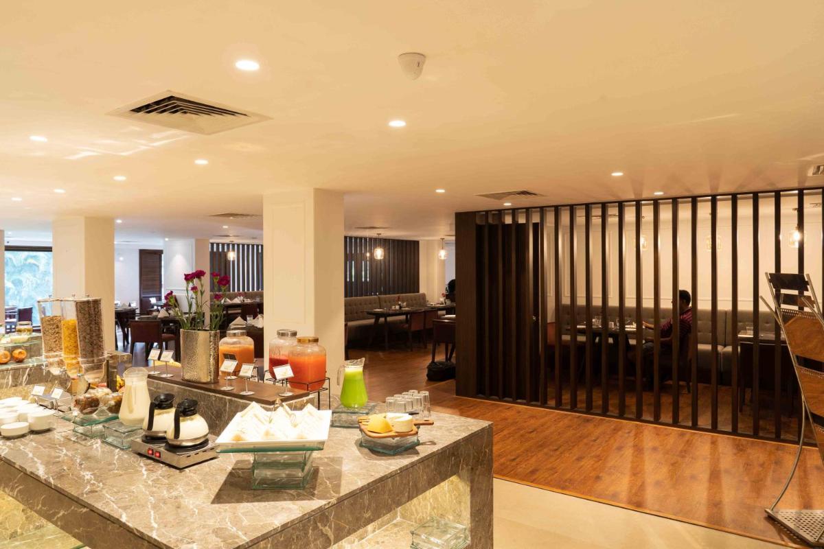 a large living room with a lobby with a table at Southern Star,Mysore in Mysore