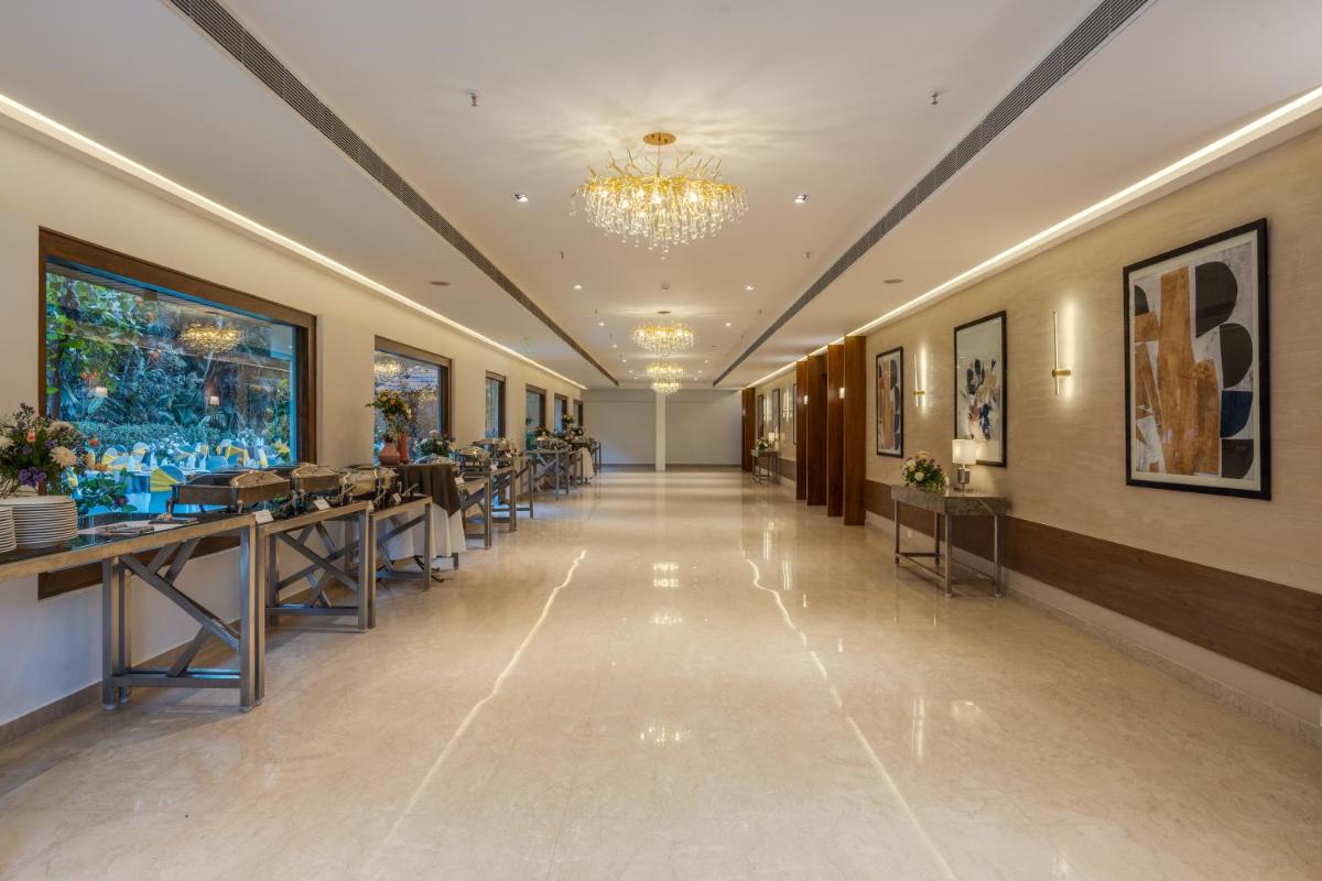 a hallway in a building with a chandelier at Southern Star,Mysore in Mysore