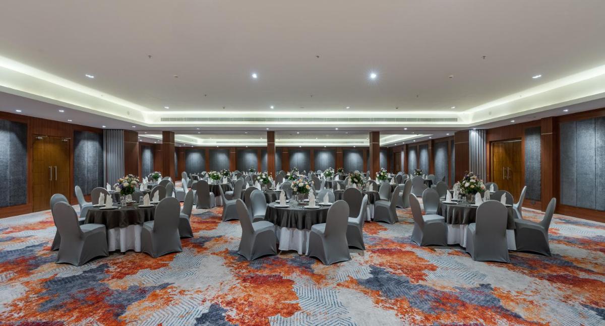 a banquet hall with tables and chairs in a room at Southern Star,Mysore in Mysore