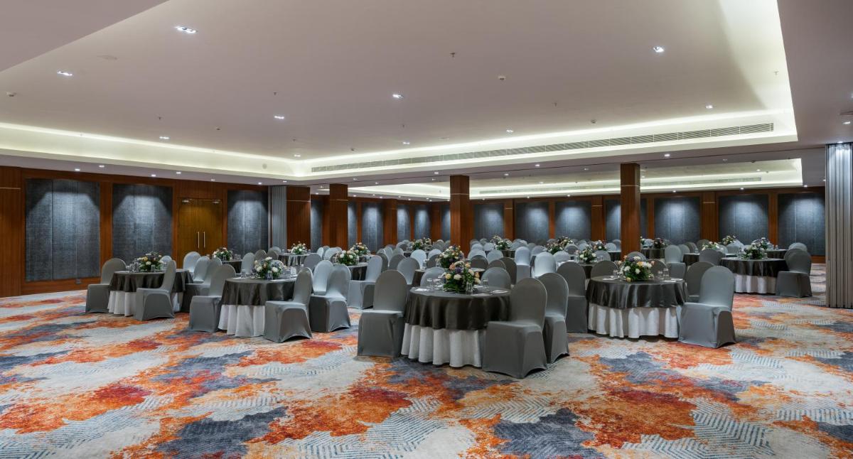 a banquet hall with tables and chairs in a room at Southern Star,Mysore in Mysore