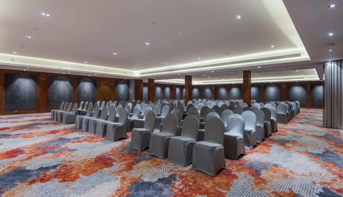 a conference room with rows of chairs on a rug at Southern Star,Mysore in Mysore