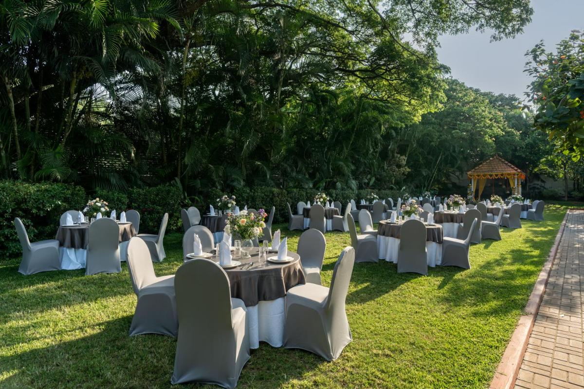 a banquet set up in the grass with tables and chairs at Southern Star,Mysore in Mysore
