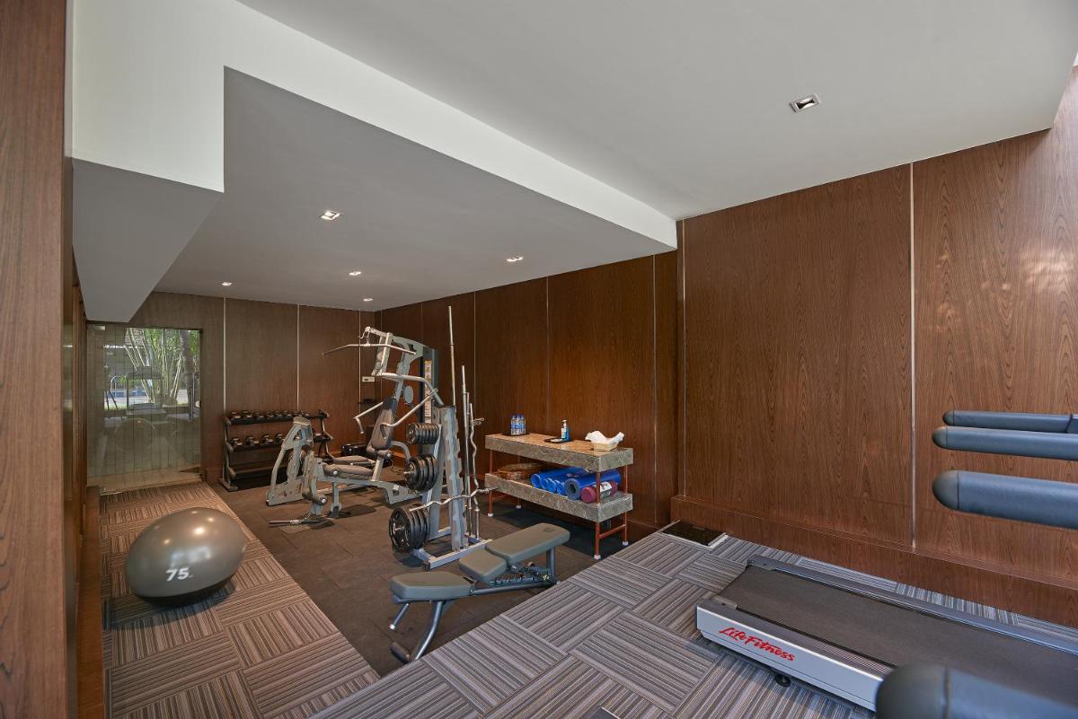 a fitness room with a gym with a treadmill at Southern Star,Mysore in Mysore
