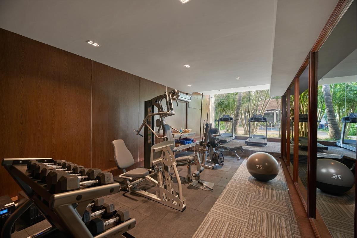 a gym with a bunch of equipment in a room at Southern Star,Mysore in Mysore