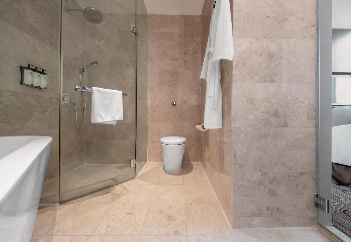 a bathroom with a shower and a toilet at The Robertson House by The Crest Collection in Singapore a bathroom with a shower and a toilet at The Robertson House by The Crest Collection in Singapore