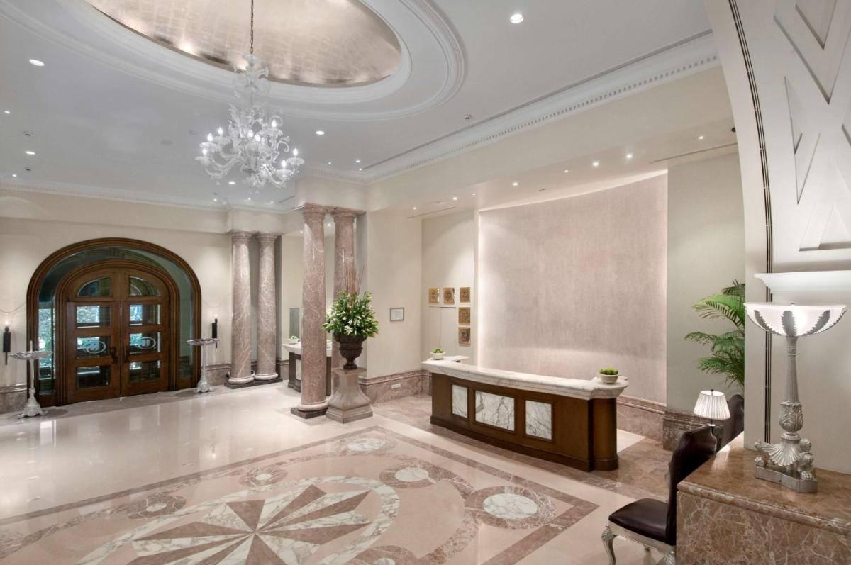 a large lobby with a table and a chandelier at Hilton Mumbai International Airport Hotel in Mumbai