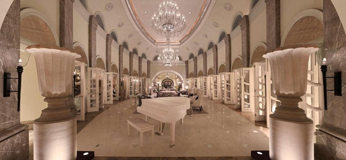 a large room with a white piano in a building at Hilton Mumbai International Airport Hotel in Mumbai