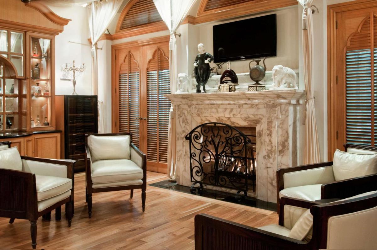 a living room with a fireplace with a tv above it at Hilton Mumbai International Airport Hotel in Mumbai