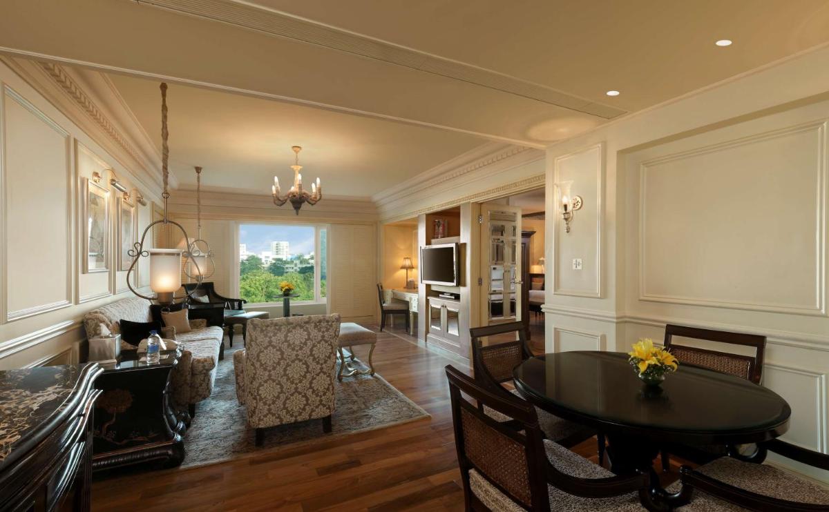 a living room with a table and a dining room at Hilton Mumbai International Airport Hotel in Mumbai