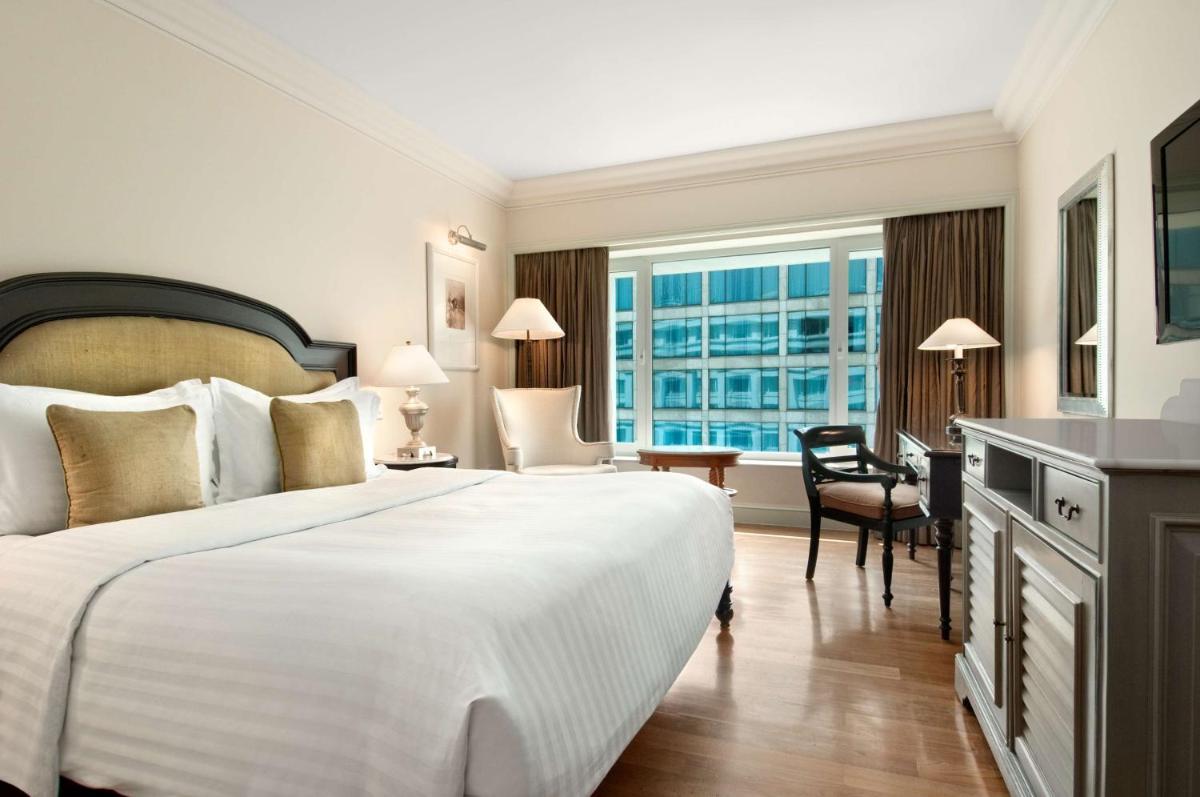 a hotel room with a large bed and a desk at Hilton Mumbai International Airport Hotel in Mumbai