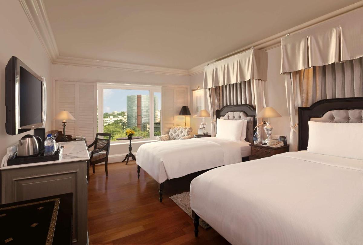a hotel room with two beds and a television at Hilton Mumbai International Airport Hotel in Mumbai