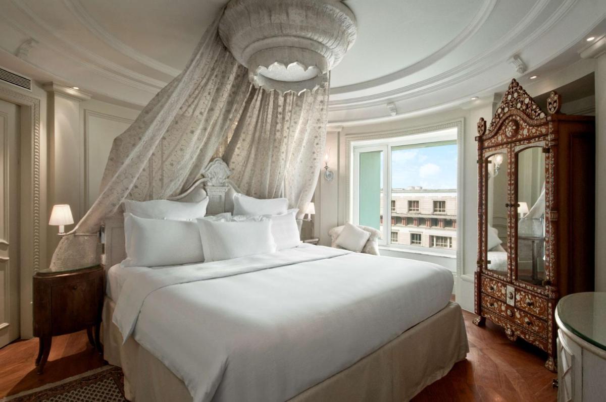 a bedroom with a large bed and a large window at Hilton Mumbai International Airport Hotel in Mumbai