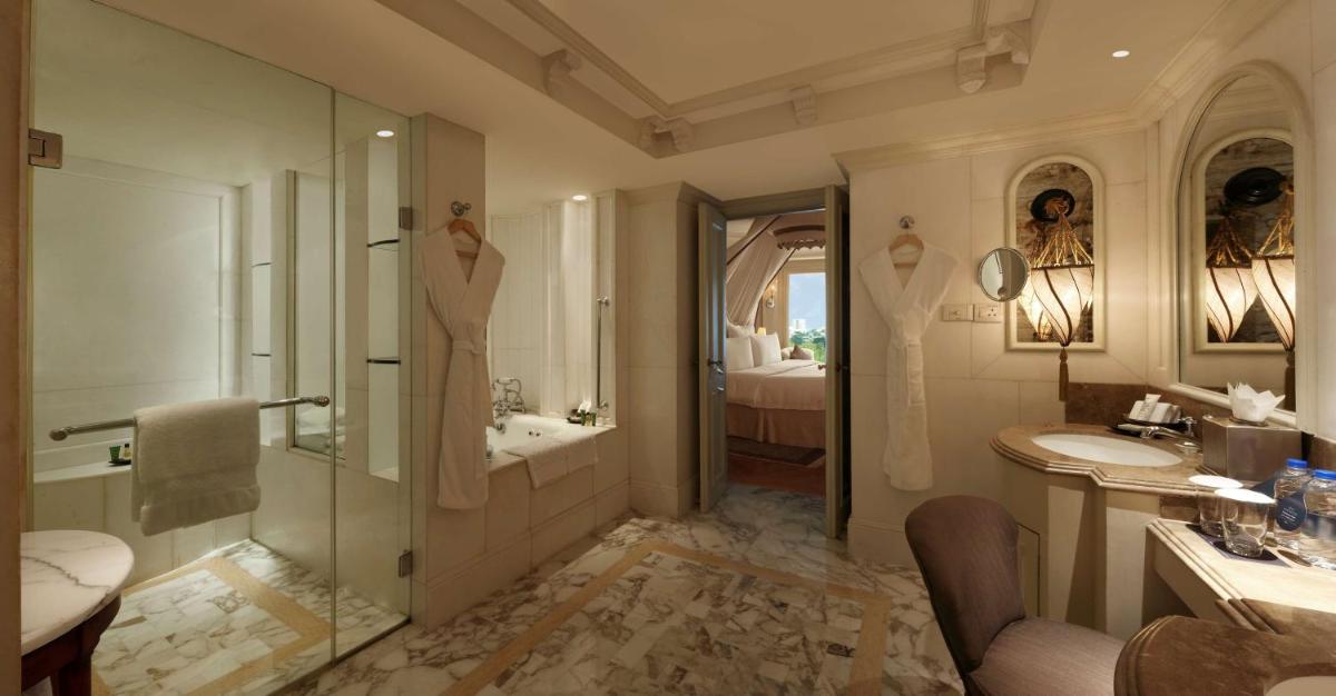 a bathroom with a shower and a sink and a tub at Hilton Mumbai International Airport Hotel in Mumbai