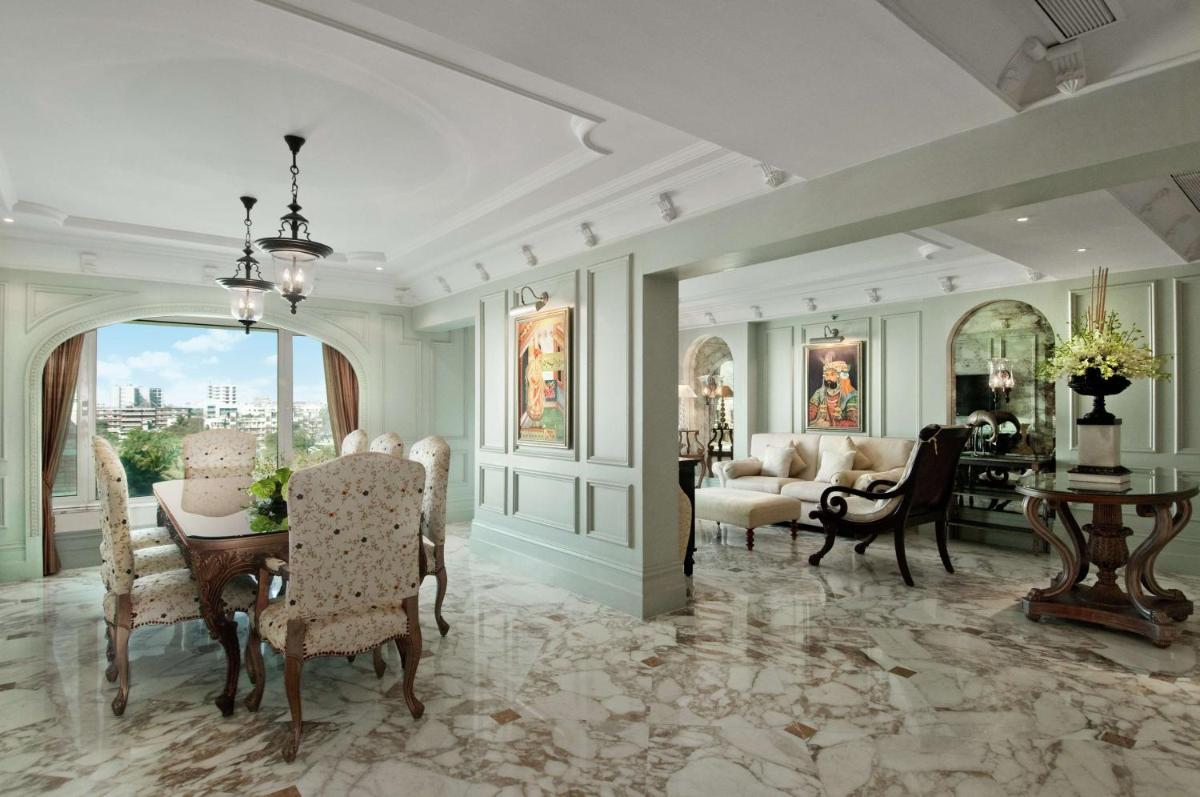 a living room with a table and chairs and a dining room at Hilton Mumbai International Airport Hotel in Mumbai