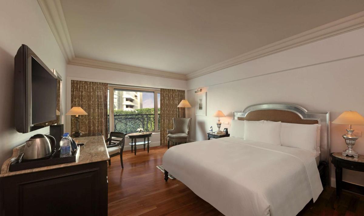 a hotel room with a bed and a television at Hilton Mumbai International Airport Hotel in Mumbai