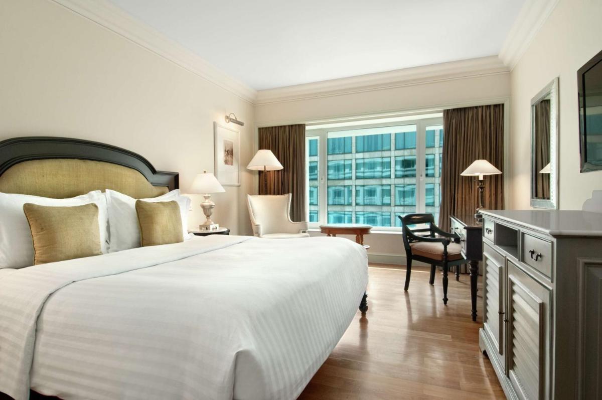 a hotel room with a large bed and a desk at Hilton Mumbai International Airport Hotel in Mumbai