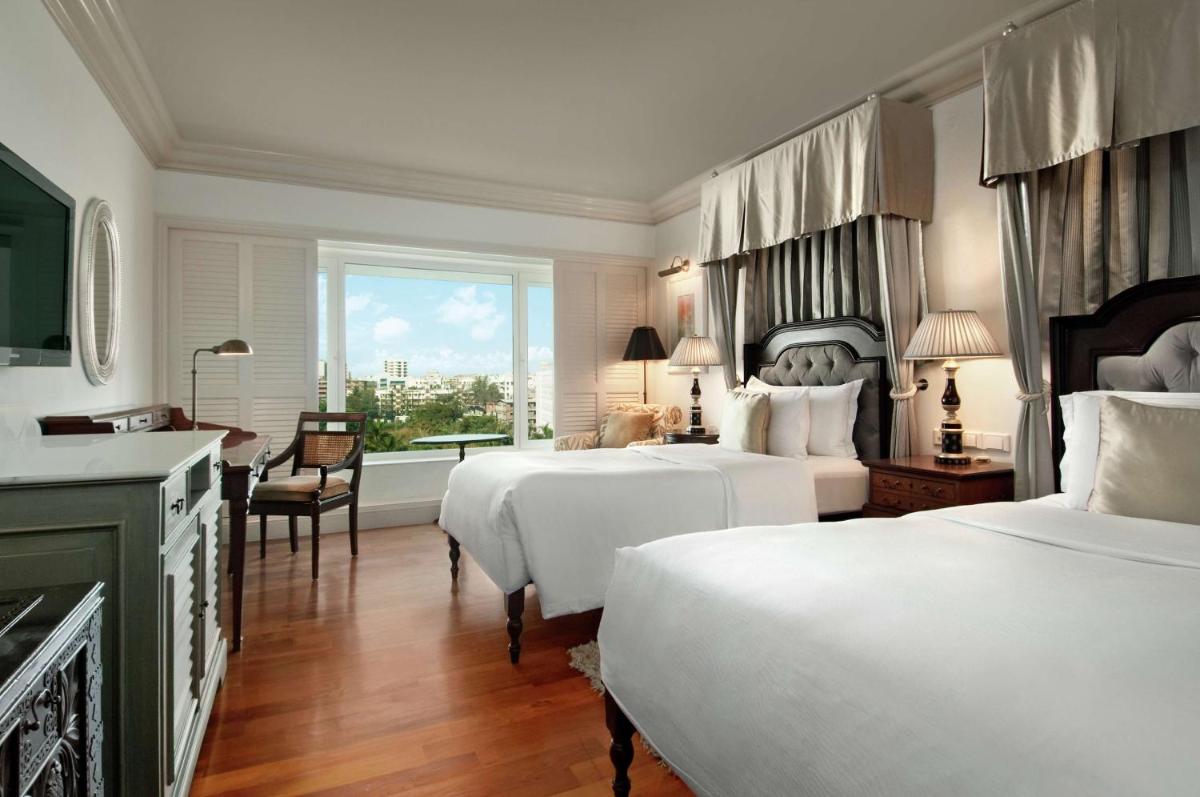 a hotel room with two beds and a window at Hilton Mumbai International Airport Hotel in Mumbai