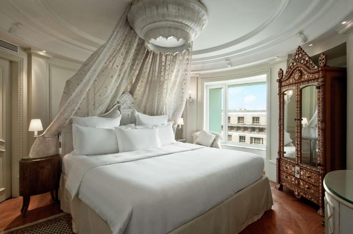 a bedroom with a large white bed and a window at Hilton Mumbai International Airport Hotel in Mumbai