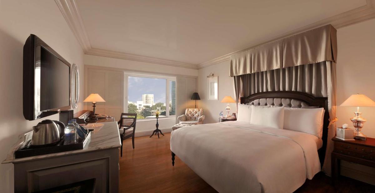 a hotel room with a large bed and a television at Hilton Mumbai International Airport Hotel in Mumbai