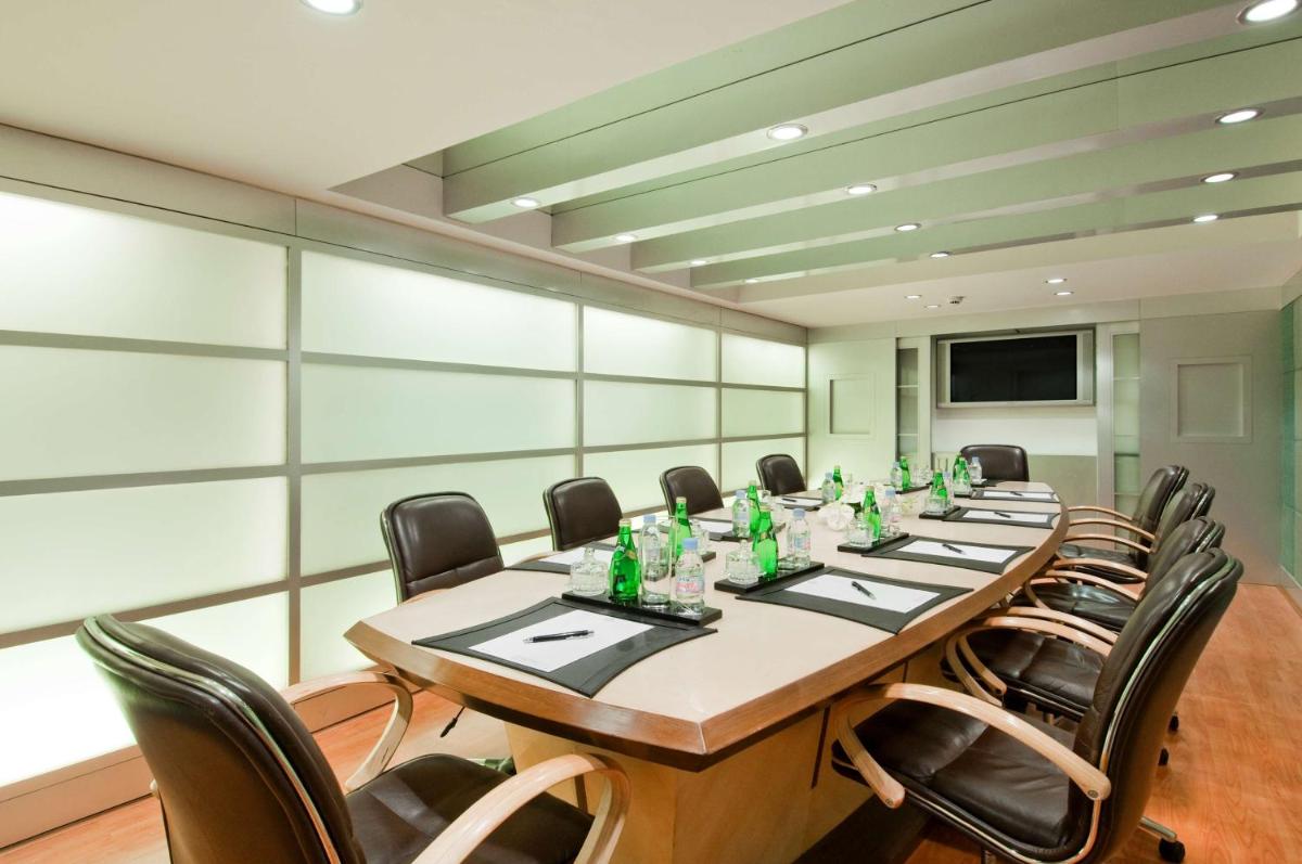 a large conference room with a long table and chairs at Hilton Mumbai International Airport Hotel in Mumbai