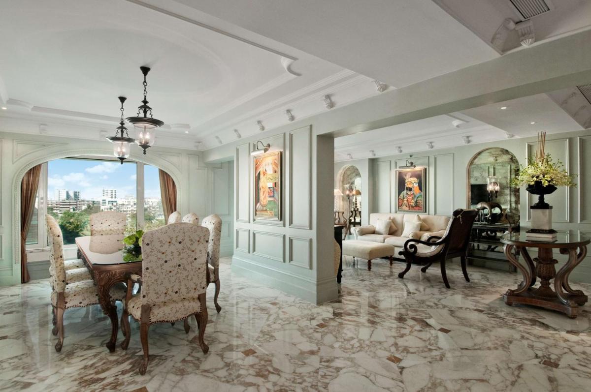 a living room with a table and chairs and a dining room at Hilton Mumbai International Airport Hotel in Mumbai