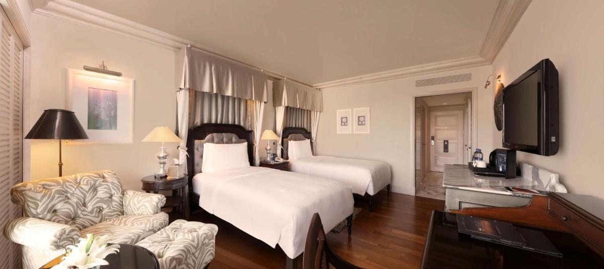 a hotel room with two beds and a television at Hilton Mumbai International Airport Hotel in Mumbai