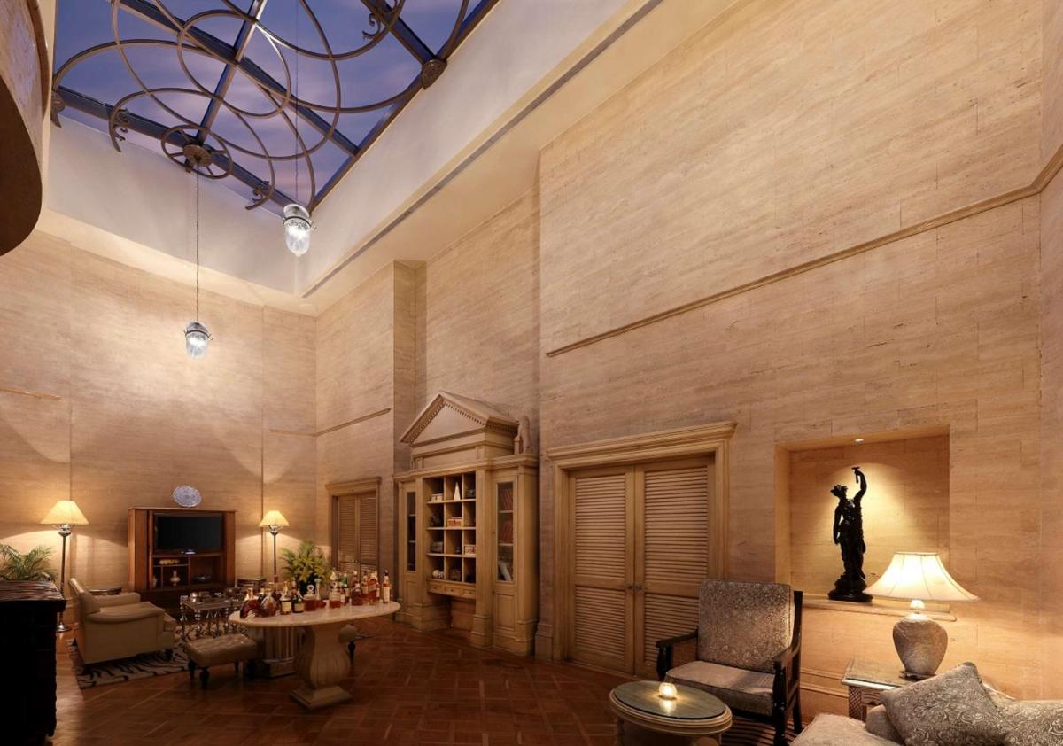 a lobby with a statue of a man on the wall at Hilton Mumbai International Airport Hotel in Mumbai