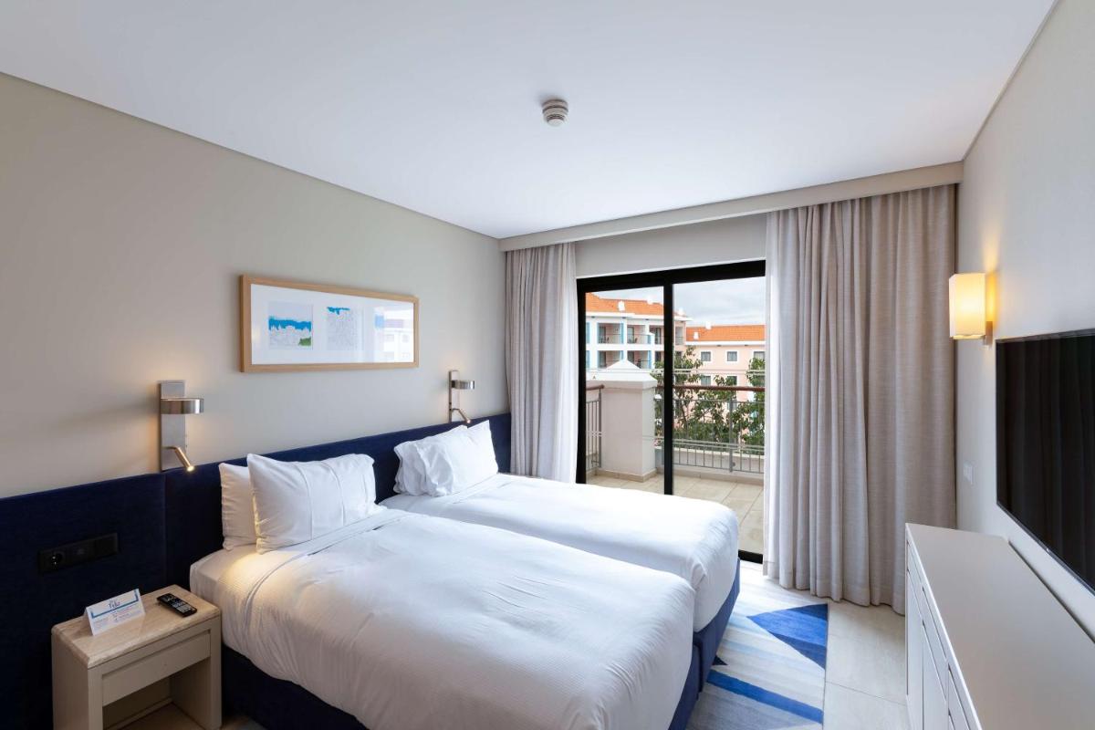 Uma cama ou camas num quarto em Hilton Vilamoura