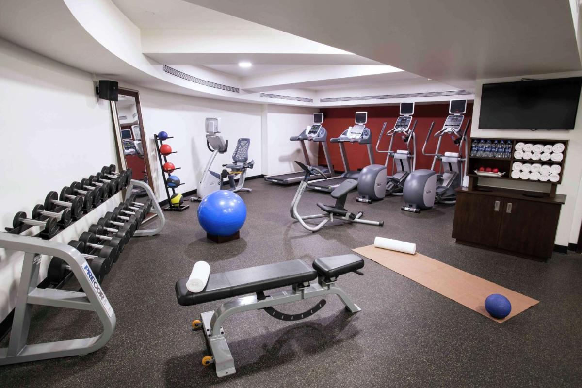 a gym with several equipment in a room at Hilton Garden Inn, Trivandrum in Trivandrum