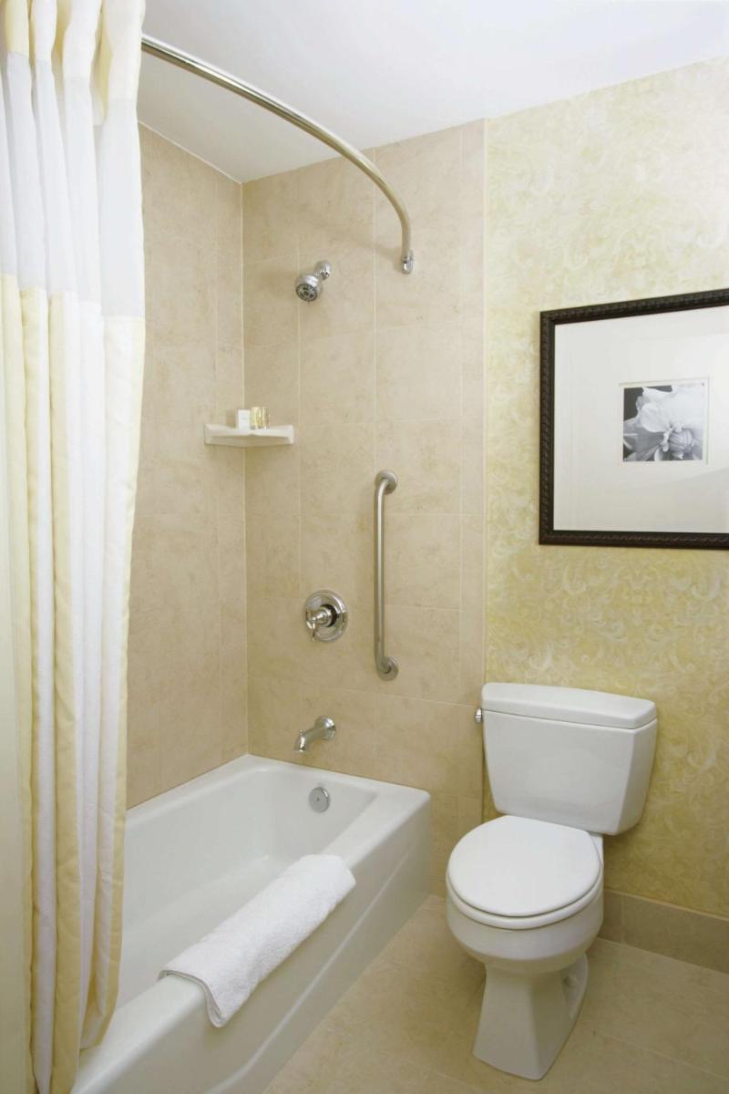 a bathroom with a toilet and a bath tub and a toilet at Hilton Garden Inn, Trivandrum in Trivandrum