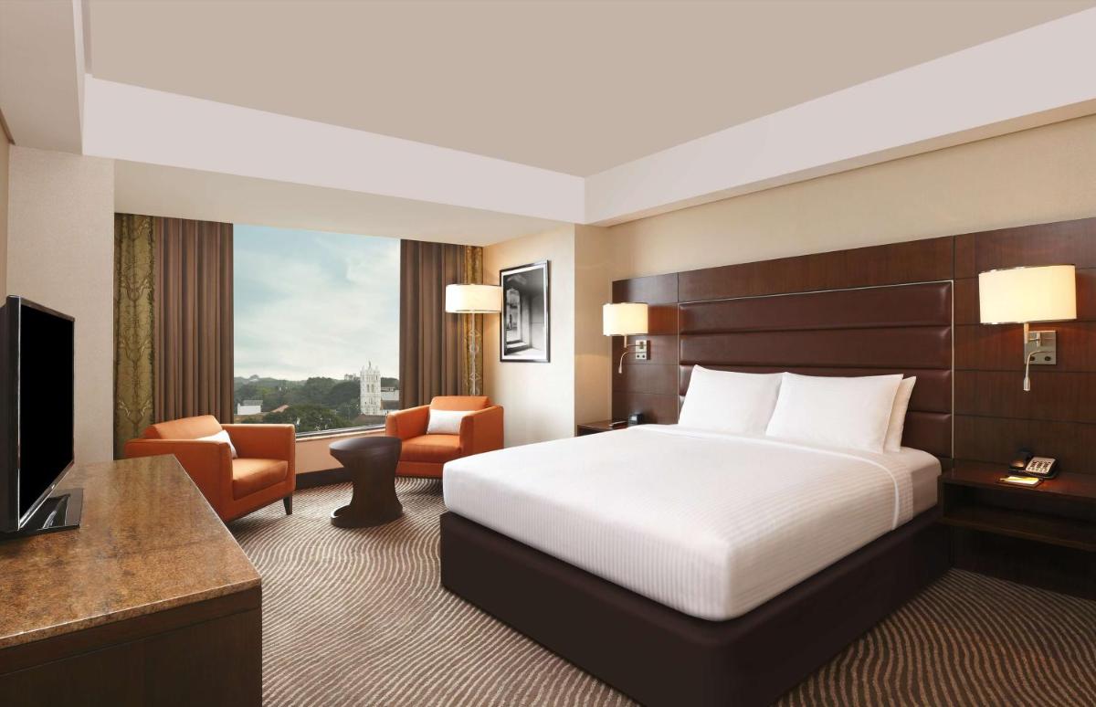 a hotel room with a bed and a television at Hilton Garden Inn, Trivandrum in Trivandrum