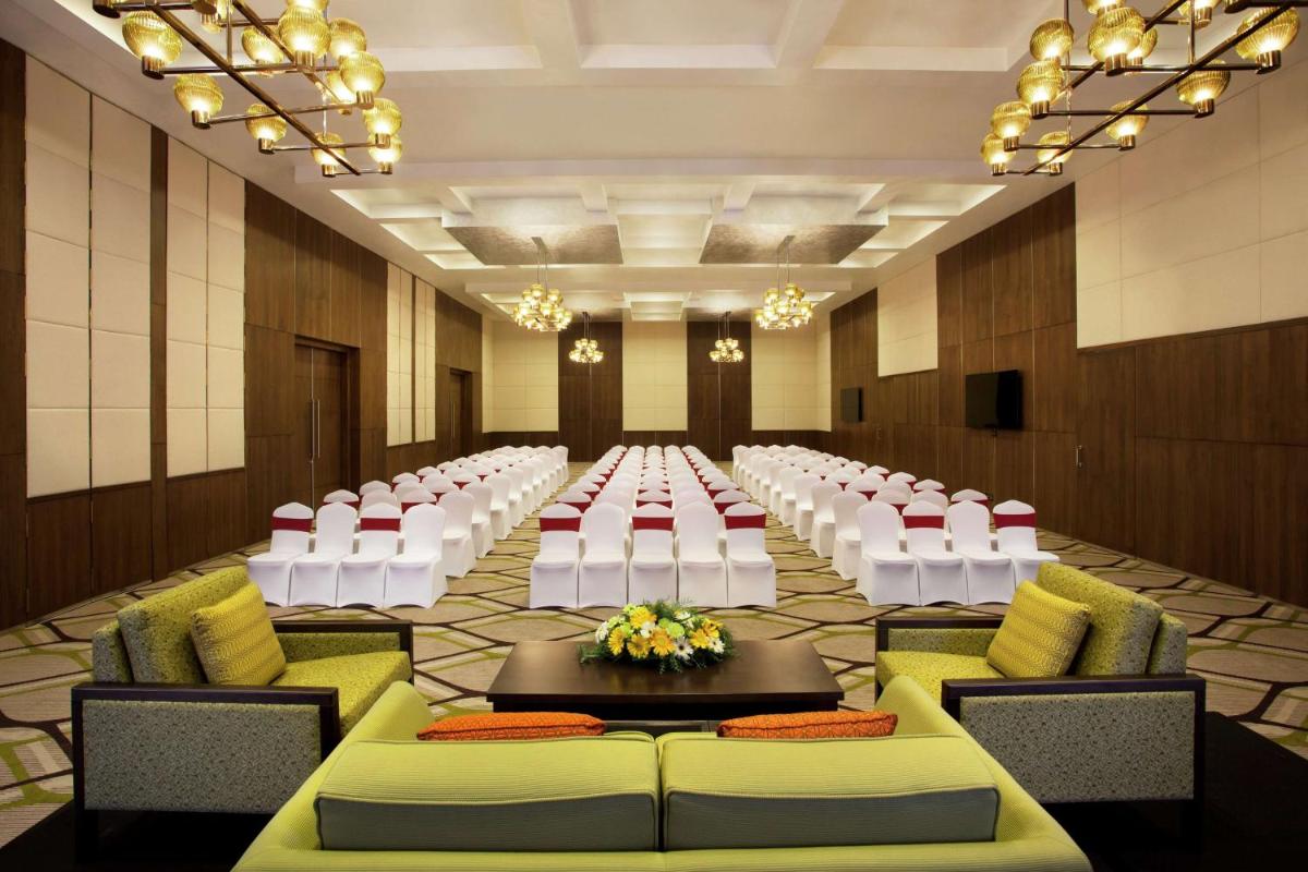 a large banquet hall with white chairs and tables at Hilton Garden Inn, Trivandrum in Trivandrum +71 photos
