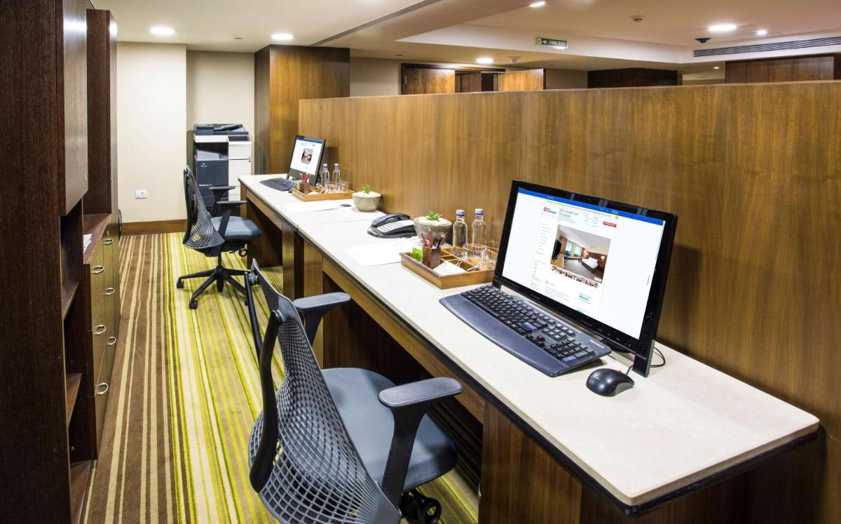 an office with a desk with a computer on it at Hilton Garden Inn, Trivandrum in Trivandrum