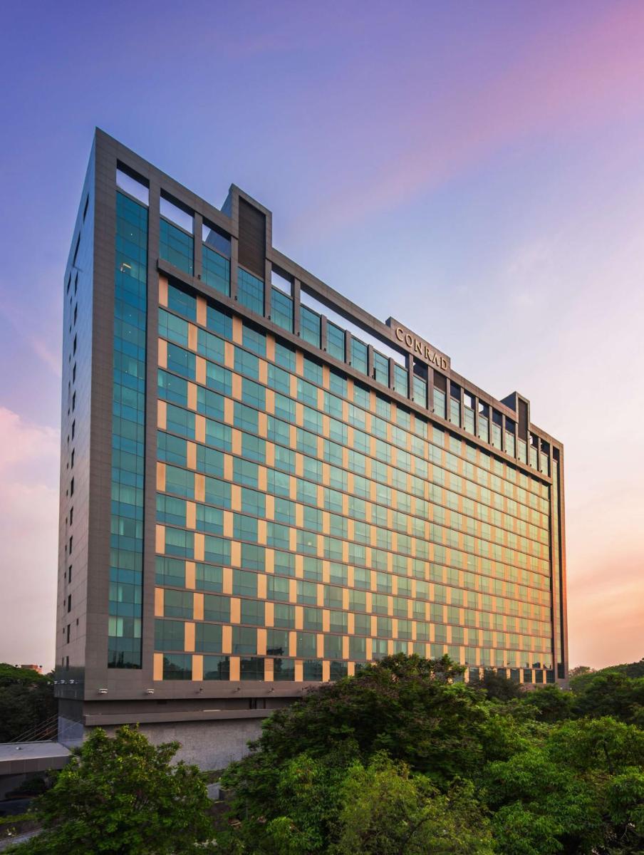 a building with a sign on the side of it at Conrad Pune in Pune