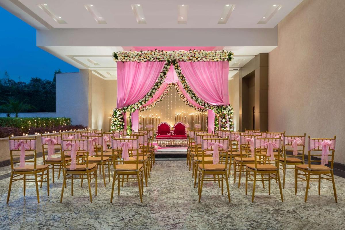 a room with a bunch of chairs and a stage at DoubleTree By Hilton Jaipur Amer in Jaipur
