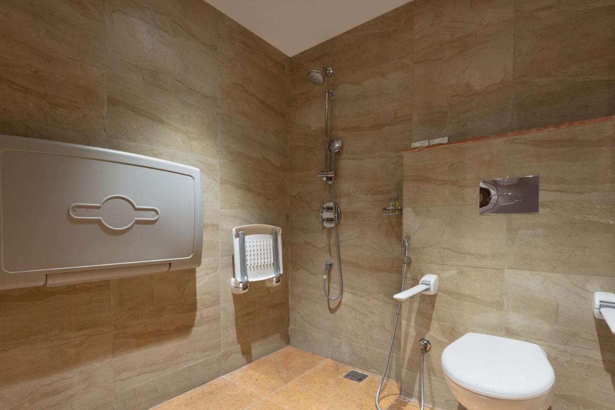 a bathroom with a shower and a toilet at DoubleTree By Hilton Jaipur Amer in Jaipur