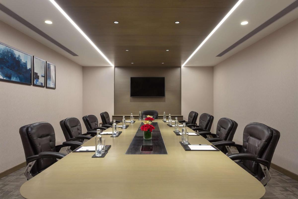 a conference room with a long table and chairs at DoubleTree By Hilton Jaipur Amer in Jaipur