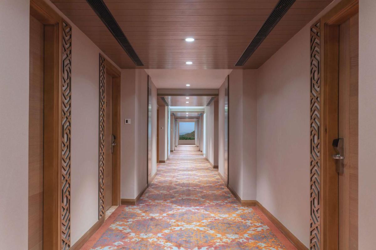 a hallway of a building with a long corridor at DoubleTree By Hilton Jaipur Amer in Jaipur