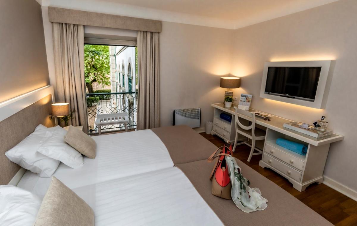 Uma cama ou camas num quarto em Grande Hotel das Caldas da Felgueira