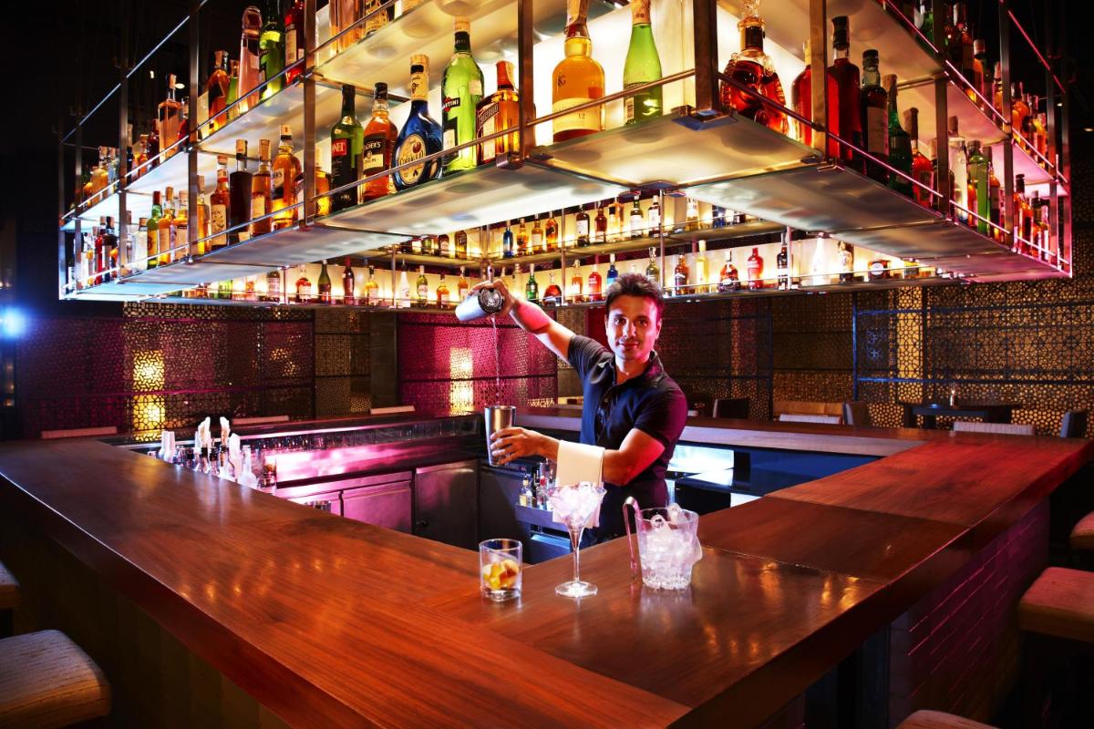 a man standing at a bar making a drink at President - IHCL SeleQtions in Mumbai