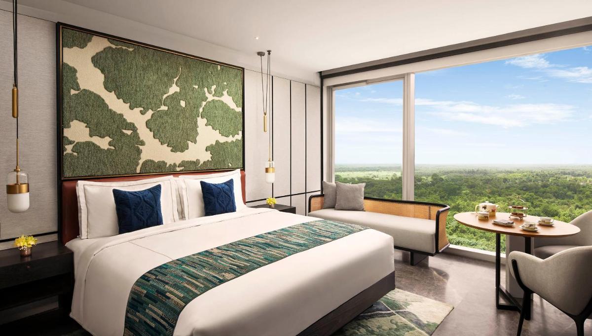a bedroom with a large bed and a large window at Taj The Trees, Mumbai in Mumbai