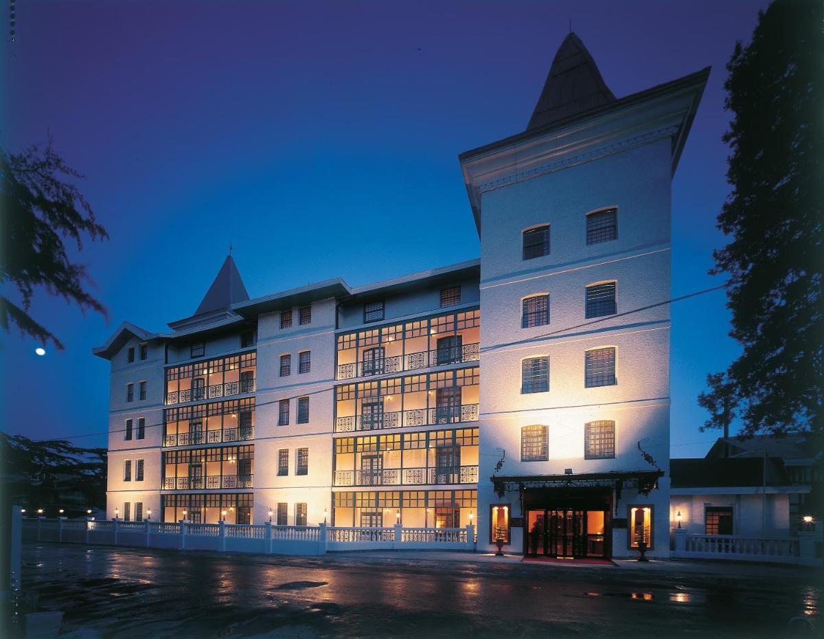 a large building is lit up at night at The Oberoi Cecil in Shimla