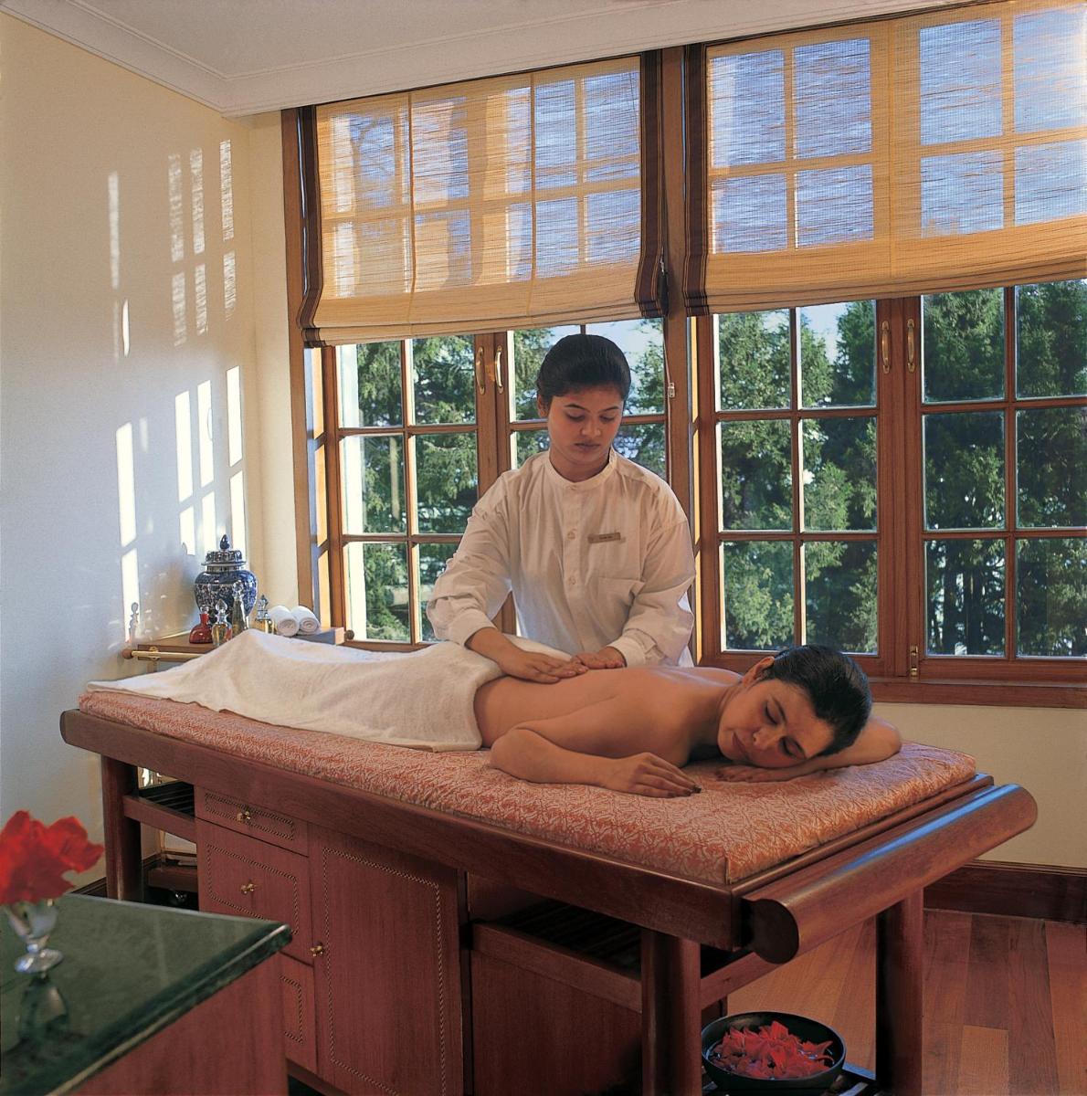 a woman laying on a massage table with a man at The Oberoi Cecil in Shimla