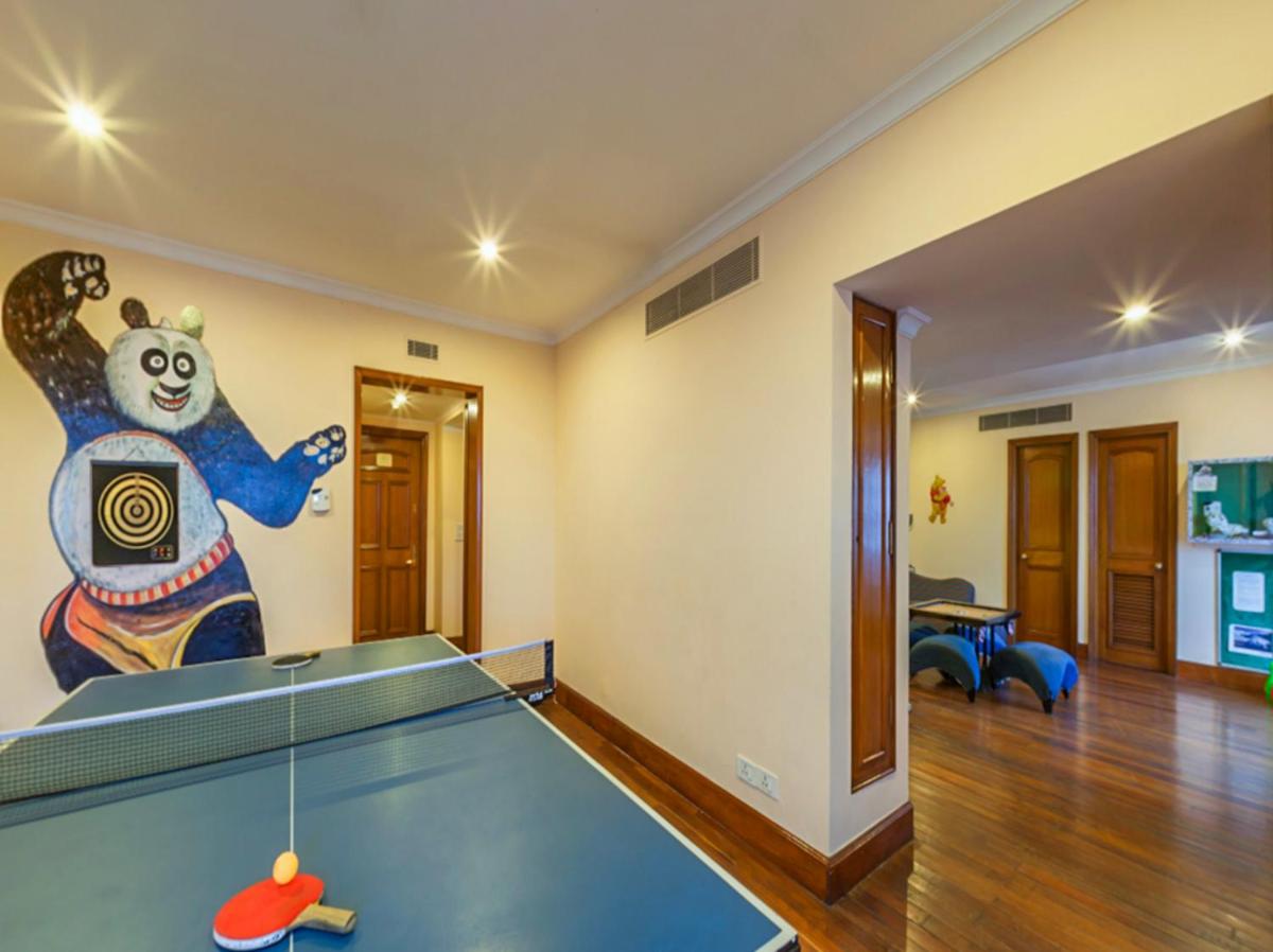 a ping pong table in a room with a mural at The Oberoi Cecil in Shimla
