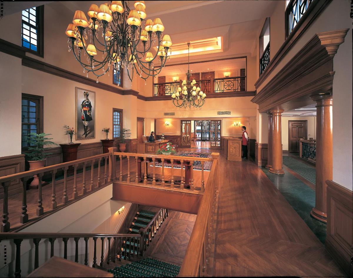 a large building with a lobby with a chandelier at The Oberoi Cecil in Shimla