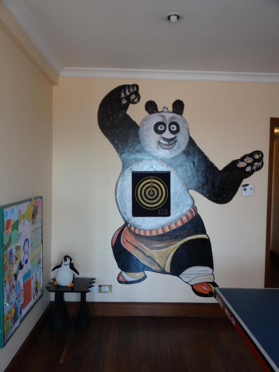 a painting of a panda bear on a wall at The Oberoi Cecil in Shimla